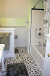 Full Bathroom with tub/shower located between two garage bedrooms